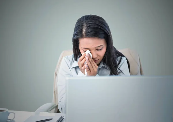 Woman crying at computer against light blue background — Stock Photo, Image