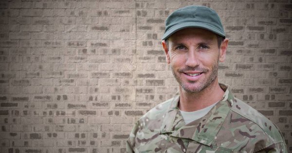 Soldier against brown brick wall