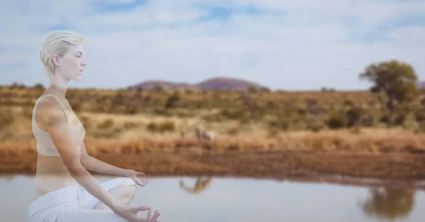 Mujer meditando junto al lago —  Fotos de Stock