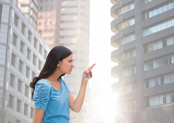 Жінка, що вказує на високі будівлі спалахують — стокове фото