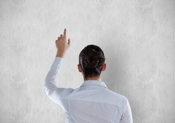 Mujer de negocios señalando en la pared blanca — Foto de Stock