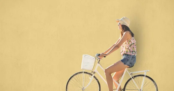 Woman riding cycle over beige background — Stock Photo, Image
