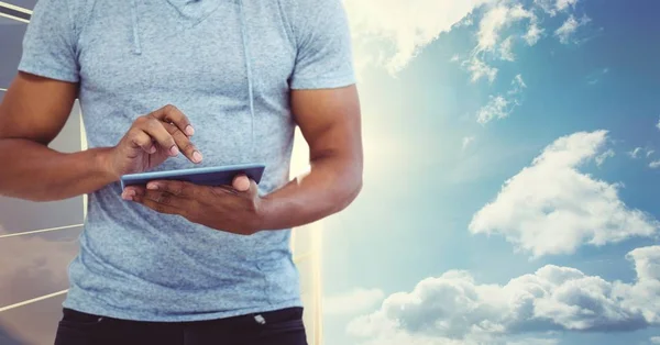 Mann fährt mit Tablet-PC gegen Himmel — Stockfoto