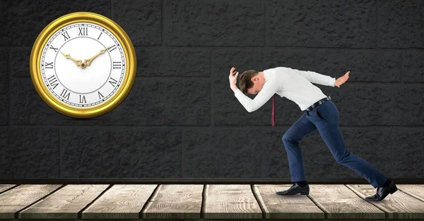 Seitenansicht eines Geschäftsmannes, der spät mit Uhr an der Wand läuft — Stockfoto