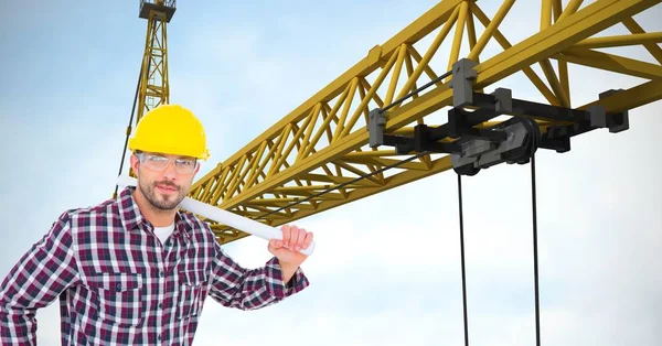 Confident architect holding blueprints by crane — Stock Photo, Image