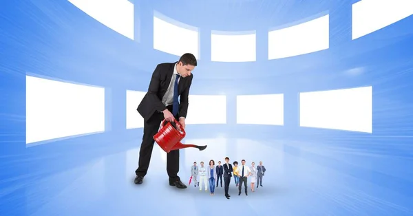 Businessman watering employees in office — Stock Photo, Image