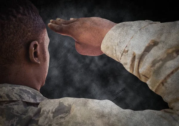 Back of soldier saluting with black grunge background and overlay — Stock Photo, Image