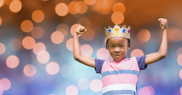 Portrait of kid wearing crown while flexing muscles — Stock Photo, Image