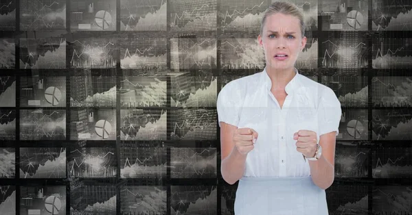 Mujer mostrando puños contra gráficos — Foto de Stock