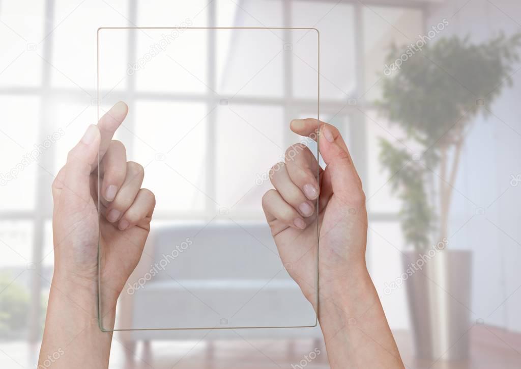 Hands holding glass screen against window