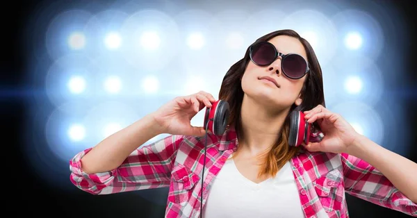 Female hipster with headphones against bright background — Stock Photo, Image