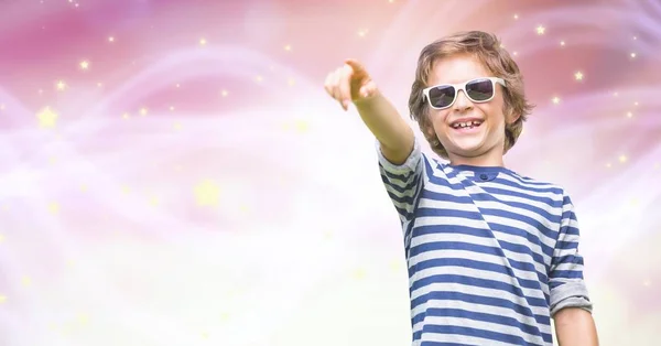 Boy wearing sunglasses while pointing — Stock Photo, Image