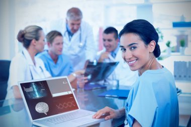 beautiful smiling doctor typing on keyboard with her team behind clipart