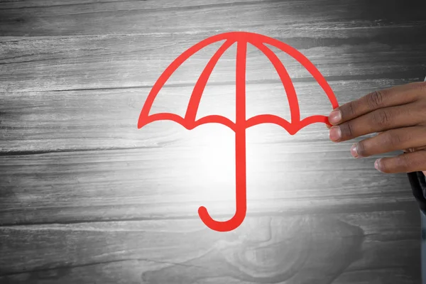Hand hält einen roten Regenschirm — Stockfoto