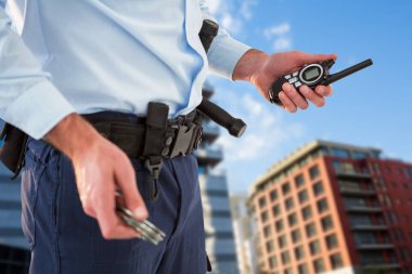 el kol ve walkie talkie tutan memur