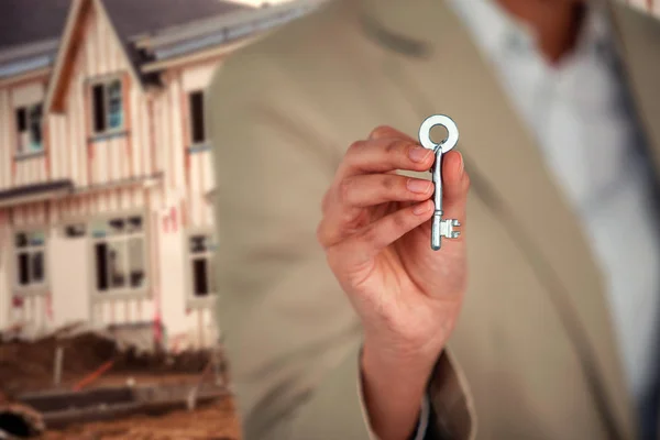 Бизнес-директор показывает ключ от дома — стоковое фото