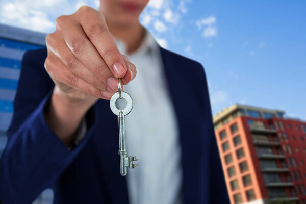 business woman showing house key
