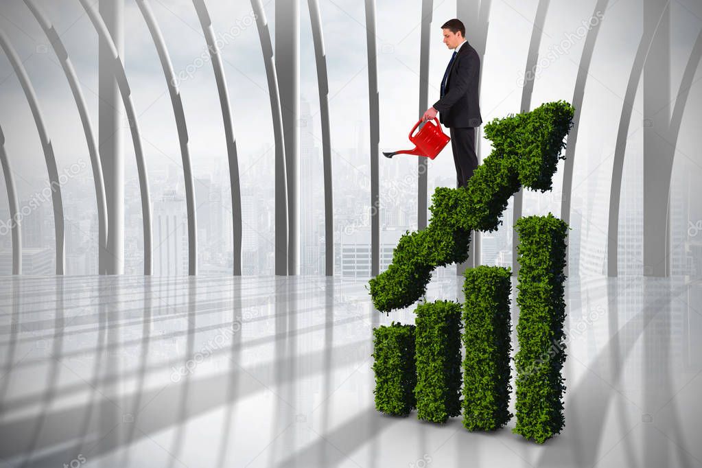 businessman holding red watering can