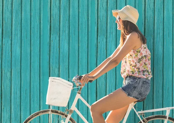 Hipster woman on the bike  with light blue wood background — Stock Photo, Image