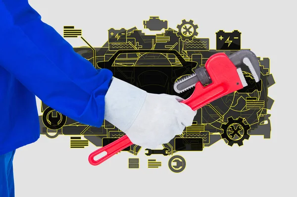 Engineer is holding a work tool against mechanic background — Stock Photo, Image
