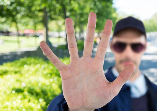 Blurred security guard saying stop with his hand in the park — Stock Photo, Image