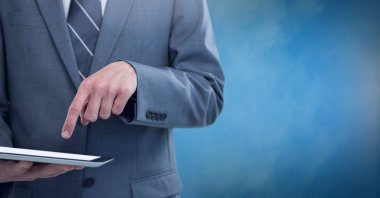 İşadamı holding tablet sisli arka plan mavi