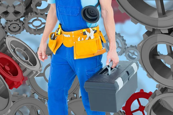 Handyman against background with 3D cogs — Stock Photo, Image