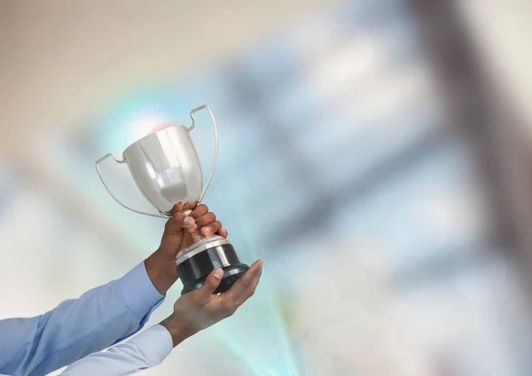 Business hand with trophy in the office — Stock Photo, Image