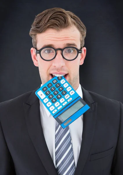 Man with calculator in mouth against navy chalkboard — Stock Photo, Image