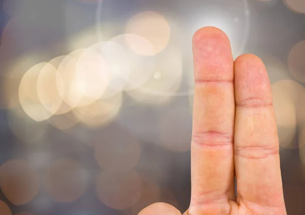 Two fingers with sparkling light bokeh background — Stock Photo, Image