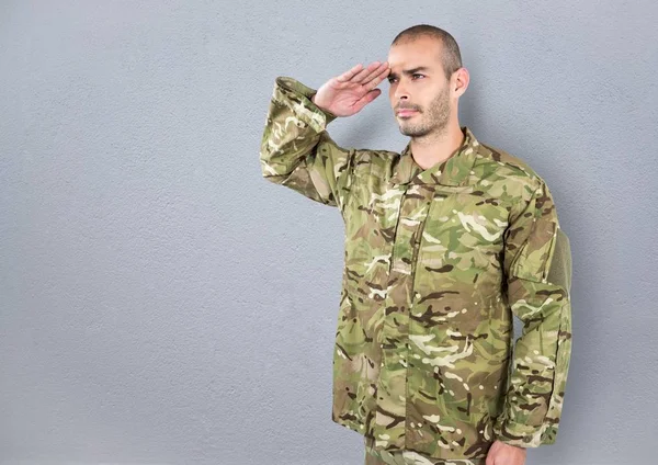 Soldier saluting. concrete wall — Stock Photo, Image
