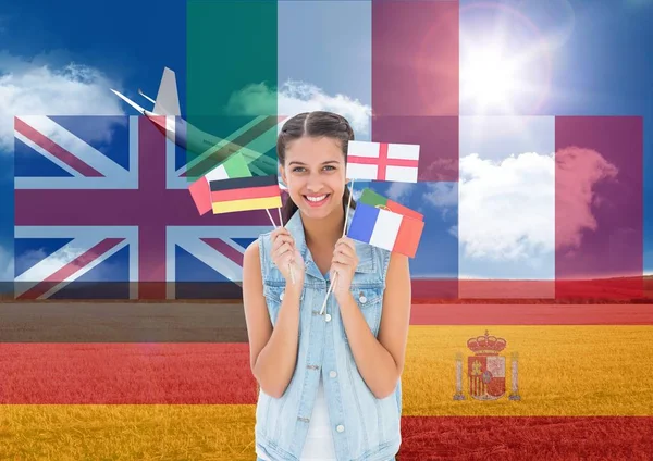 Flaggor runt ung kvinna med flaggor med plan bakom i fältet — Stockfoto