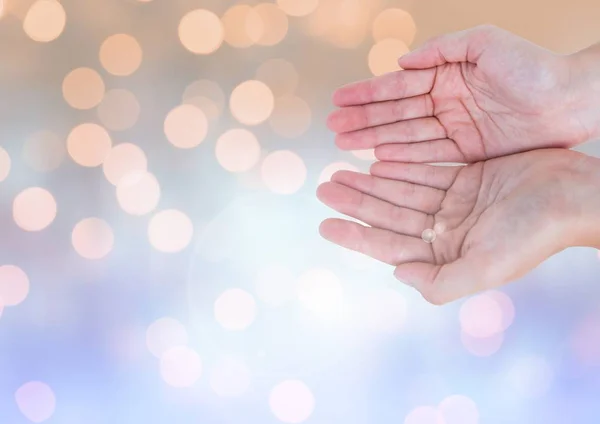 Hands open together with sparkling light bokeh background — Stock Photo, Image