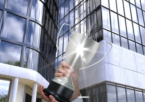 Business hand with trophy with flare, in front of business building — Stock Photo, Image