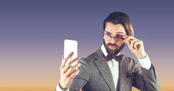 Hipster homem com óculos tomando uma selfie no fundo azul — Fotografia de Stock