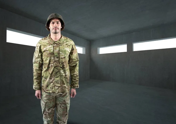 Soldier with helmet in dark concrete room — Stock Photo, Image