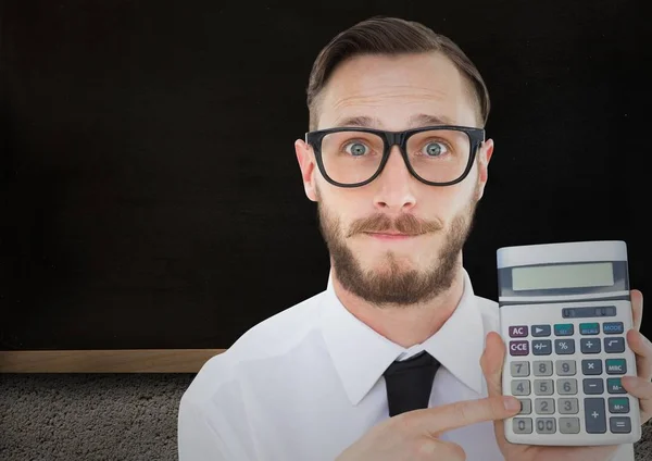 Man with calculator against blackboard — Stock Photo, Image
