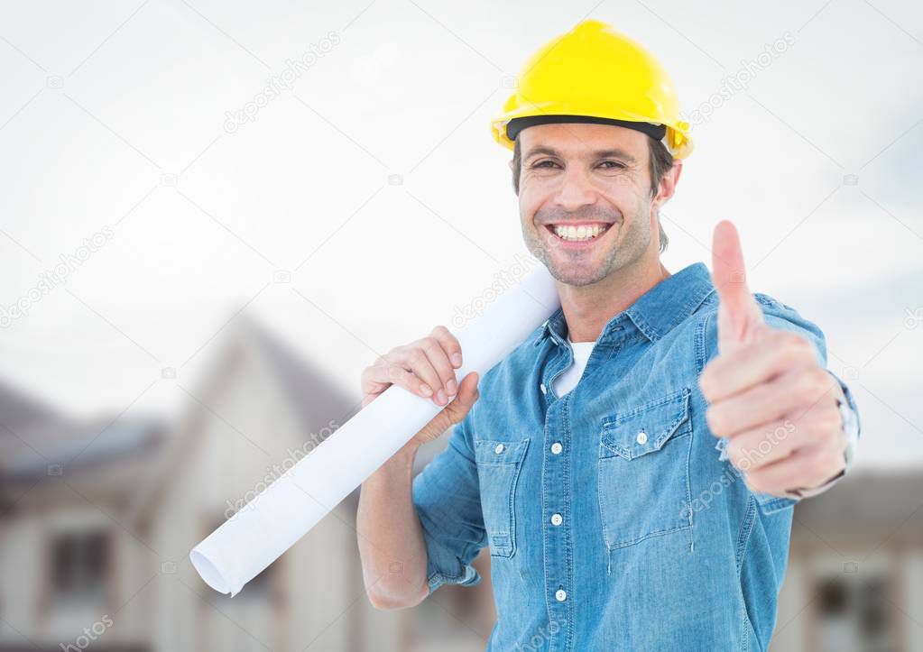 Architect with blueprints on building site