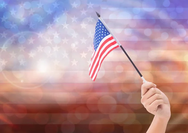 Mano con bandera americana con luz brillante fondo bokeh —  Fotos de Stock