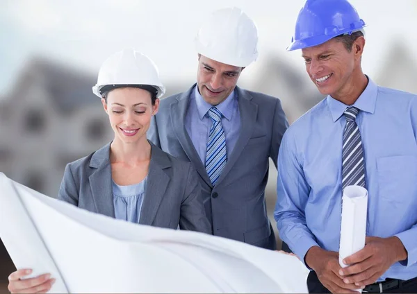 Architects with blueprints on building site — Stock Photo, Image