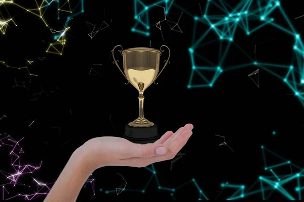 Hand holding a trophy against atomic structure background — Stock Photo, Image