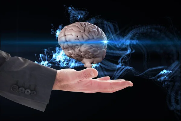 Рука бизнесмена держит мозг на черном абстрактном фоне — стоковое фото