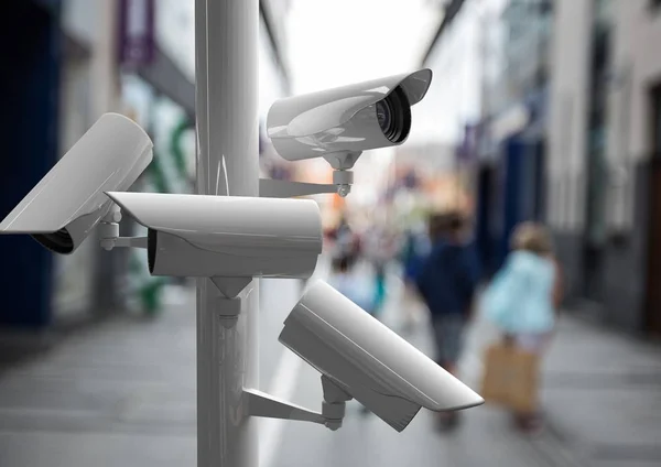 Камеры видеонаблюдения на улице с людьми за ней — стоковое фото