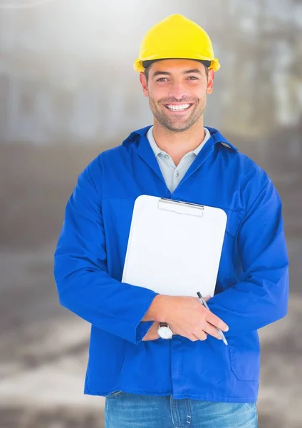 Trabajador de la construcción con carta de la pluma en frente del sitio de construcción — Foto de Stock