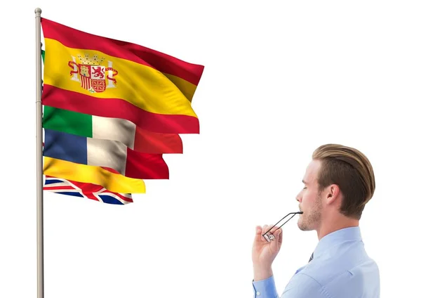 Flags near young businessman thinking and looking to the flags — Stock Photo, Image