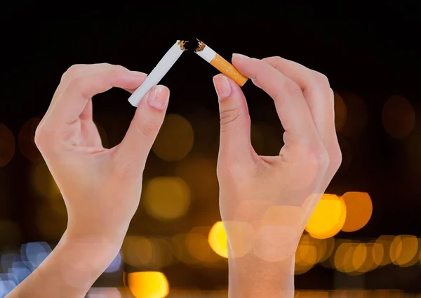 Mano rasgando el cigarrillo para dejar de fumar con luz brillante fondo bokeh — Foto de Stock