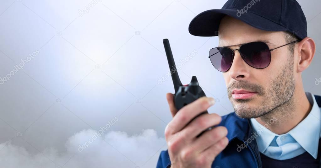 Security man outside with bright background clouds