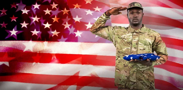 Soldier holding american flag — Stock Photo, Image