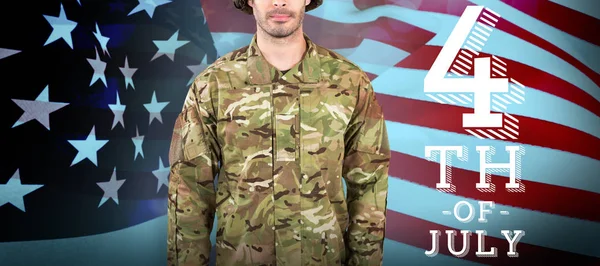 Soldier standing against usa flag — Stock Photo, Image