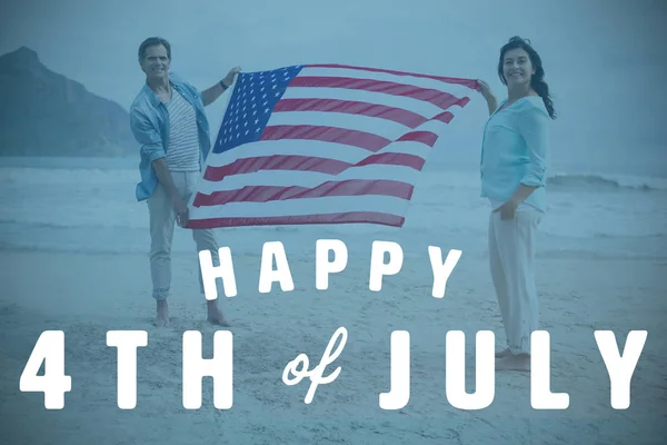 Gazdaság amerikai zászló, a strand pár — Stock Fotó